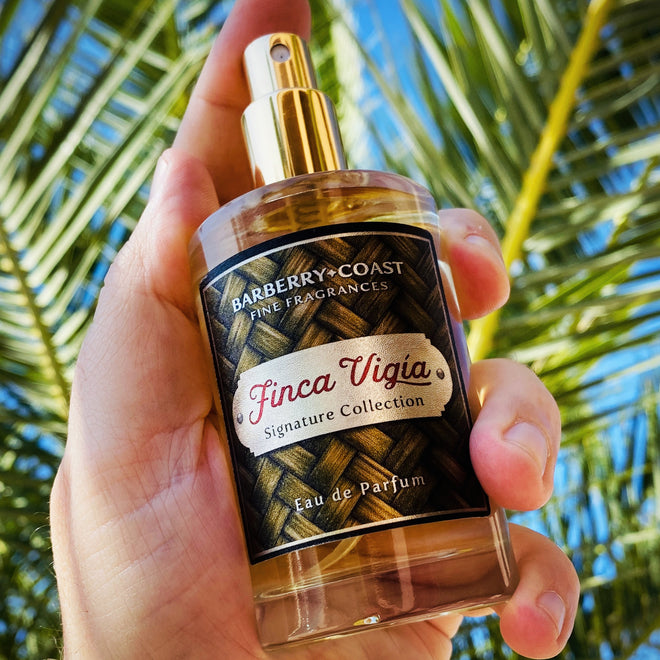 Finca Vigia Signature Collection Eau de Parfum in a 100ml glass bottle with spray atomizer - by Barberry Coast. Palm tree fronds in the background,