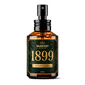 A 60ml amber glass spray bottle with a black pump dispenser, featuring a dark green and gold label for 'Barberry Coast 1899 Extrait Reserve'.