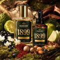 Two Barberry Coast 1899 fragrance bottles displayed among natural ingredients and forest elements. The larger clear bottle on the left contains pale golden liquid with a gold cap and dark green label, while the smaller amber spray bottle on the right has a black pump and matching dark green label.