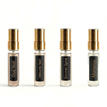 Four fragrance bottles with gold caps and black labels on a white background. Barberry Coast After Dark Fragrance Discovery Set