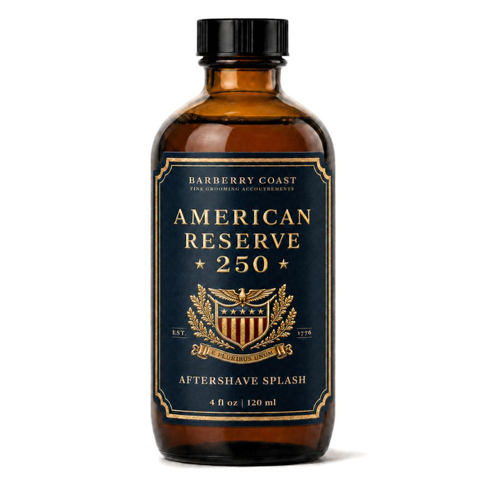 A 4 fl oz amber glass bottle of Barberry Coast American Reserve 250 Aftershave Splash with a black cap and a navy blue label with gold lettering and crest.