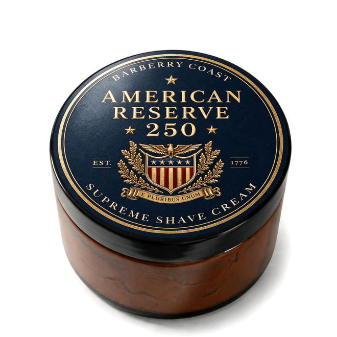 A round amber glass jar of Barberry Coast American Reserve 250 Supreme Shave Cream, featuring a dark navy blue lid with gold lettering and a red and gold crest.