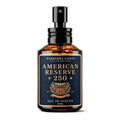 A 60 ml amber glass spray bottle of Barberry Coast American Reserve 250 Eau de Parfum, featuring a black pump and a navy blue label with gold lettering.