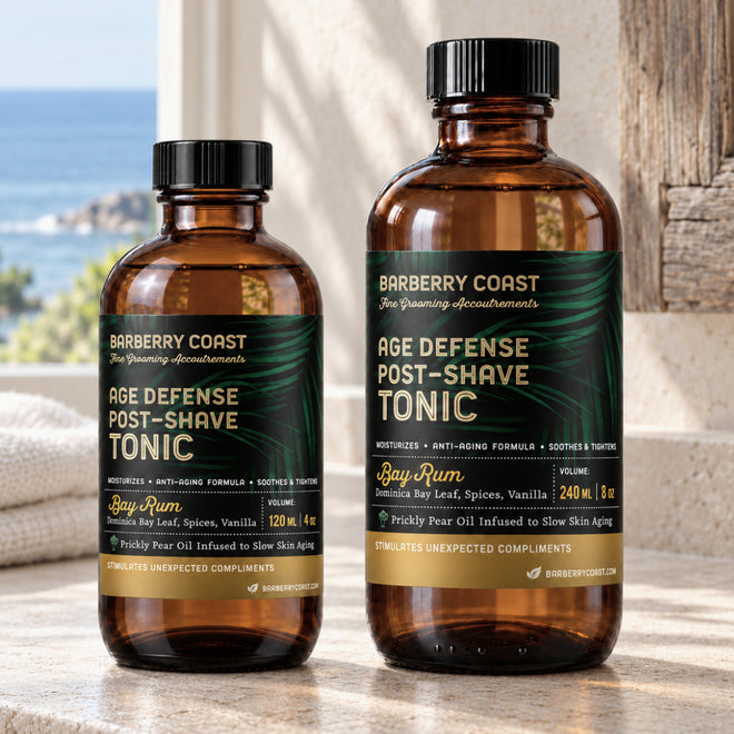 Barberry Coast Bay Rum Age Defense Post-Shave Tonic in 4 oz and larger 8 oz amber bottles with green and gold labels, side by side on a sunlit stone countertop and an ocean view.