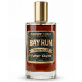 A 100ml glass bottle of Bay Rum Dominican Extract Reserve fragrance by Barberry Coast Fine Fragrances, featuring amber liquid, a gold cap, and a dark green and gold label.
