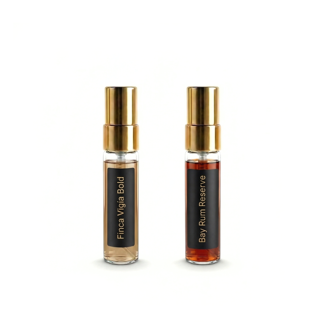 Two small bottles of fragrances with gold caps on a white background. Barberry Coast Extrait Discovery Set.