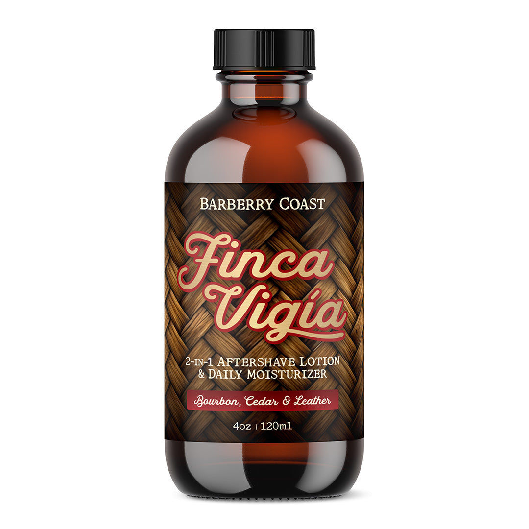 A bottle of Barberry Coast Finca Vigia Aftershave Lotion with a clear amber glass packaging and a black cap. The label features green leaf graphics and displays the product name and scent profile.