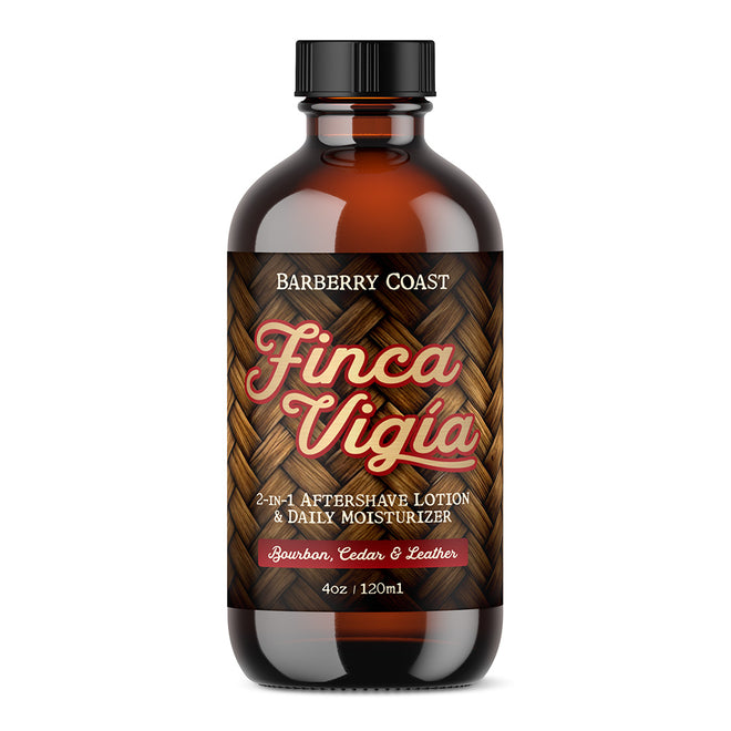 A bottle of Barberry Coast Finca Vigia Aftershave Lotion with a clear amber glass packaging and a black cap. The label features green leaf graphics and displays the product name and scent profile.