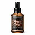 Finca Vigia Eau de Perfume Cologne bottle by Barberry Coast. Standard 2oz clear amber-colored apothecary bottle with a black atomizer sprayer cap. Lookout home in Havana, Cuba.