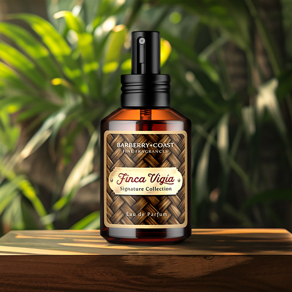 Finca Vigia Eau de Perfume Cologne bottle with new updated label design by Barberry Coast. Standard 2oz clear amber-colored apothecary bottle with a black atomizer sprayer cap. Inspired by Ernest Hemingway's -also known as Papa - home in Havana, Cuba.