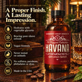 Barberry Coast Havana Aftershave Splash in a red-labeled amber bottle on a wooden table in a warmly lit lounge, with icons highlighting glycerin hydration, refreshing post-shave care, a vegan formula and USA craftsmanship.