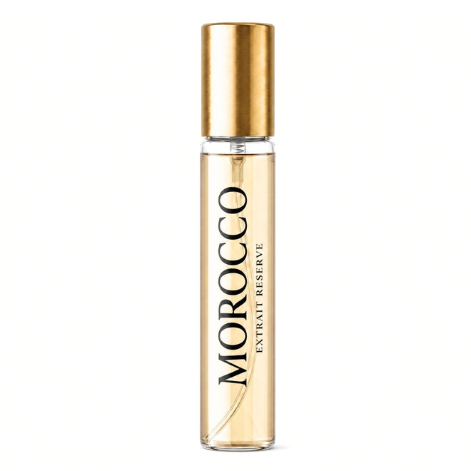 Morocco Extract Reserve perfume rollerball bottle with a gold cap and clear glass body showing the golden liquid inside, set against a plain white background.