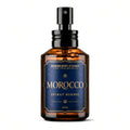 An amber glass spray bottle with a black pump dispenser and a dark blue label featuring gold lettering. The label reads 'BARBERRY COAST FINE FRAGRANCES', 'MOROCCO', and 'EXTRAIT RESERVE'.