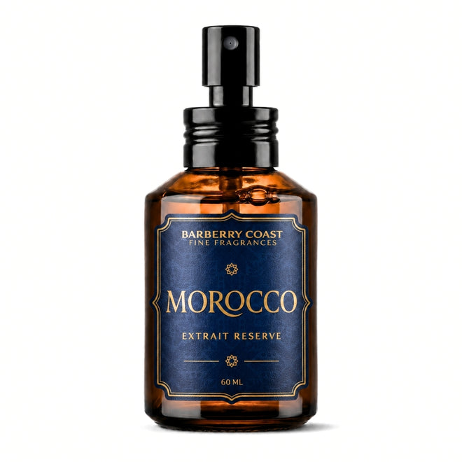 An amber glass spray bottle with a black pump dispenser and a dark blue label featuring gold lettering. The label reads 'BARBERRY COAST FINE FRAGRANCES', 'MOROCCO', and 'EXTRAIT RESERVE'.