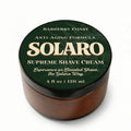 Jar of Solaro Supreme Shave Cream with green lid and brown body on a white background