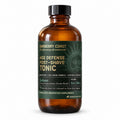 Barberry Coast Solaro Age Defense Tonic in a 4 oz amber bottle with a black cap, muted green label featuring a sun illustration and gold lettering, on a white background.