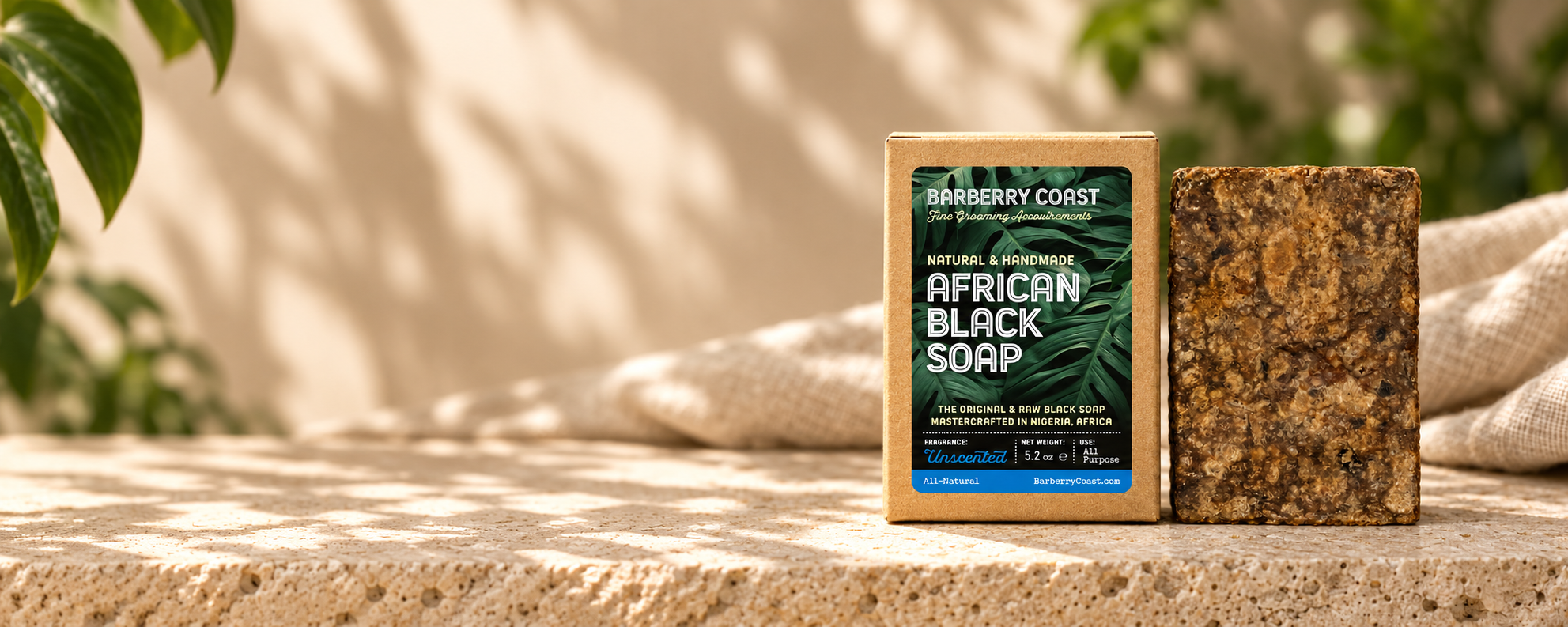 African Black Soap and its box together on the right of a sunlit limestone scene, with open space on the left.