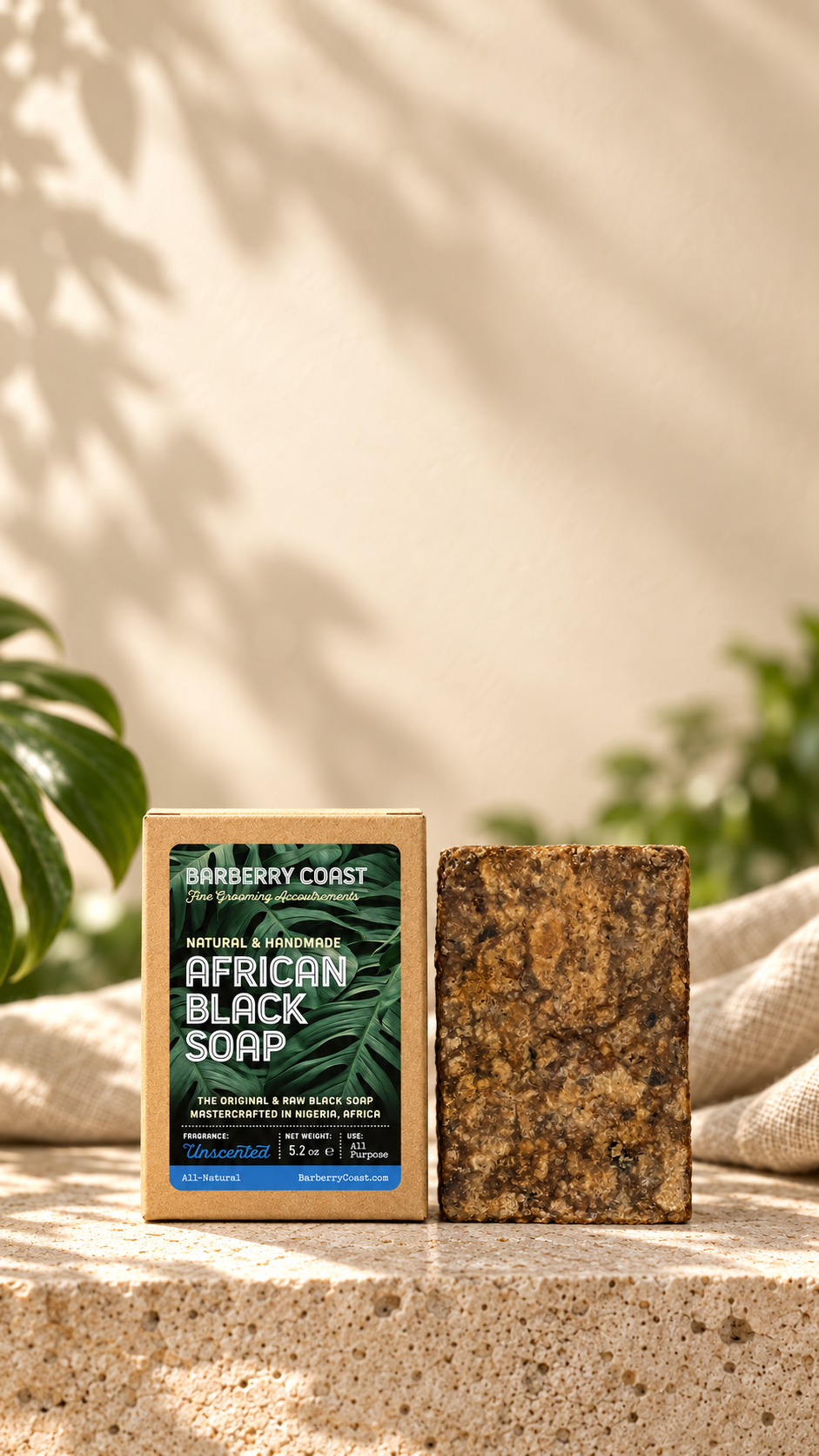 African Black Soap and its box on limestone beneath a tall, softly lit natural background.