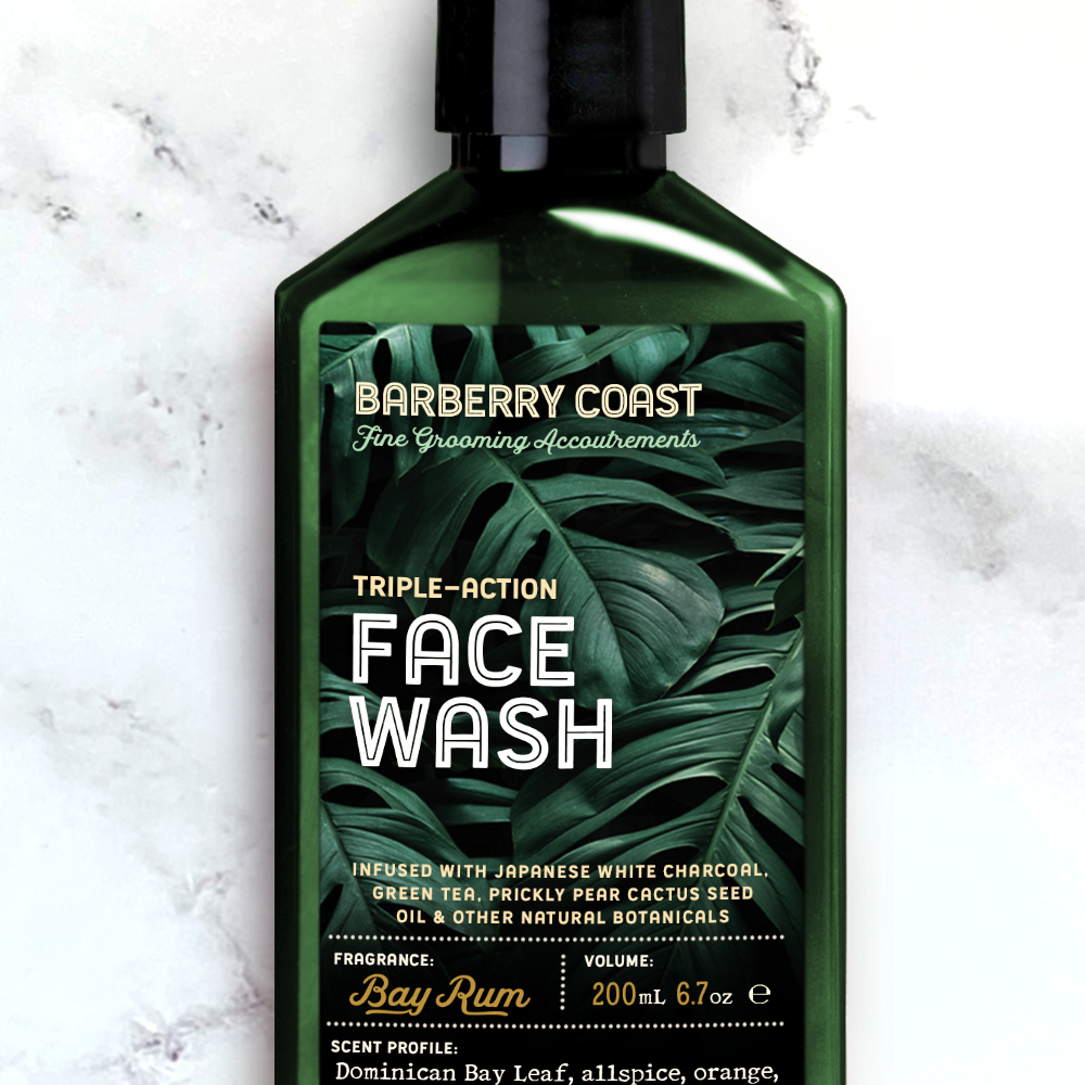 Triple-action Charcoal Face Wash Cleanser (Bay Rum) in a green pump bottle on a marble background
