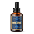 Souks of Morocco Cologne - a clear amber colored apothecary style cologne bottle with a black atomizer spray cap. Glass bottle has a blue and gold label with the words "Souks of Morocco eau de parfum by Barberry Coast"