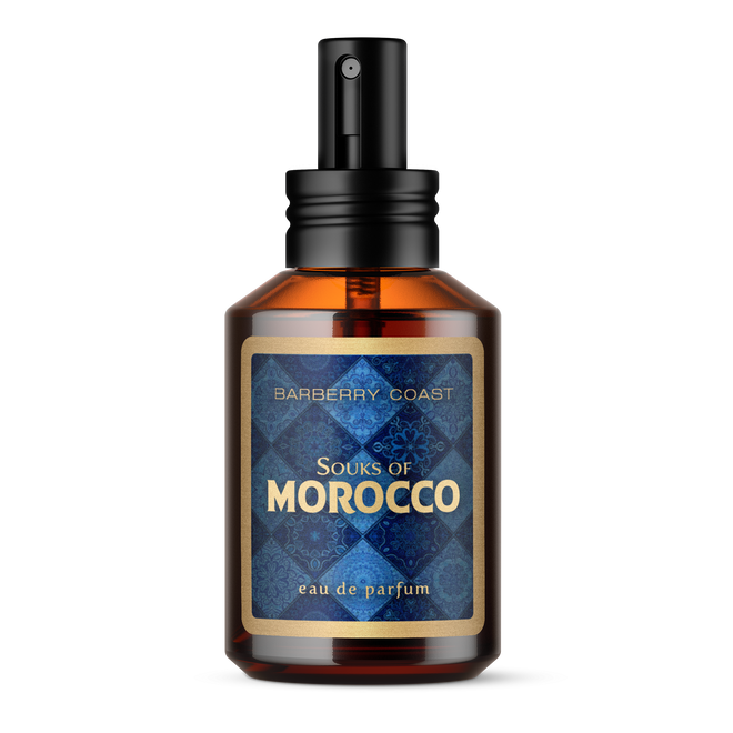 Souks of Morocco Cologne - a clear amber colored apothecary style cologne bottle with a black atomizer spray cap. Glass bottle has a blue and gold label with the words "Souks of Morocco eau de parfum by Barberry Coast"
